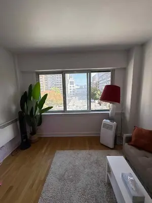 a living room with a couch and a window at Cozy 1BDR in Prime location - Walk to Everything in Montréal