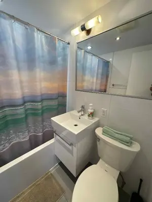 a bathroom with a white toilet and a sink at Cozy 1BDR in Prime location - Walk to Everything in Montréal