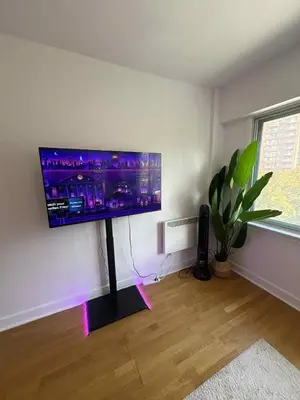 a living room with a flat screen tv on a wall at Cozy 1BDR in Prime location - Walk to Everything in Montréal