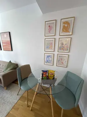 a living room with a glass table and two chairs at Cozy 1BDR in Prime location - Walk to Everything in Montréal