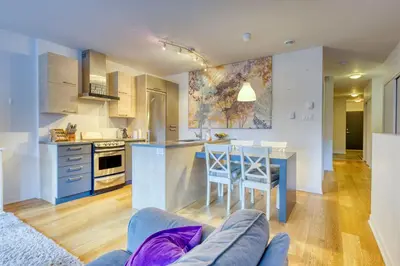 a kitchen and living room with a table and chairs at Condo McGill University in Montréal