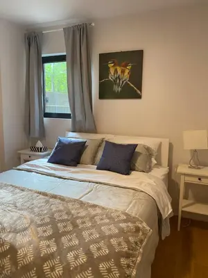 a bedroom with a large bed with blue pillows at Condo McGill University in Montréal