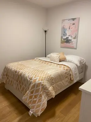 a bedroom with a bed and a painting on the wall at Condo McGill University in Montréal