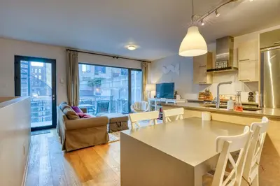 a kitchen and living room with a table and chairs at Condo McGill University in Montréal