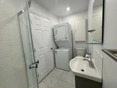 a bathroom with a sink and a toilet and a mirror at Appartement simple ou double 2313#1M in Montréal