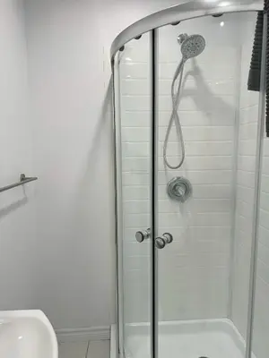 a shower with a glass door in a bathroom at Appartement simple ou double 2313#1M in Montréal