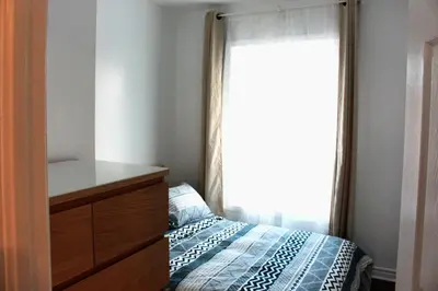 a bedroom with a bed with a dresser and a window at Magnifique 2 chambre 2311#3M in Montréal