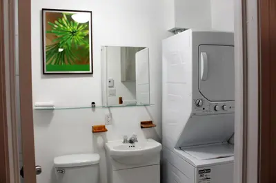 a white bathroom with a sink and a toilet at Magnifique 2 chambre 2311#3M in Montréal