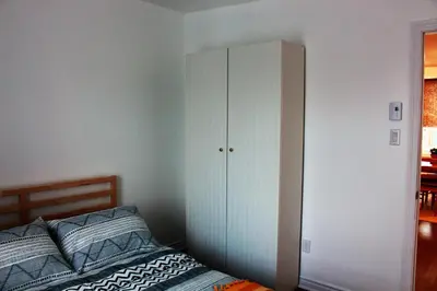a bedroom with a white cabinet next to a bed at Magnifique 2 chambre 2311#3M in Montréal