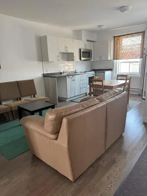 a living room with a couch and a kitchen at Magnifique 2 chambre 2311#3M in Montréal