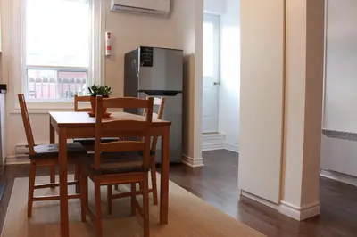 a kitchen with a table and chairs and a refrigerator at Magnifique 2 chambre 2311#3M in Montréal