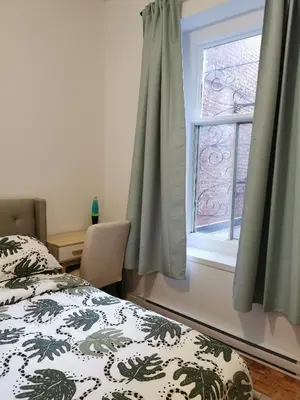 a bedroom with a bed and a window at Grand Appartement centre-ville 1227, 3 chambres in Montréal