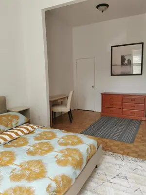 a bedroom with a bed and a dresser and a desk at Grand Appartement centre-ville 1227, 3 chambres in Montréal