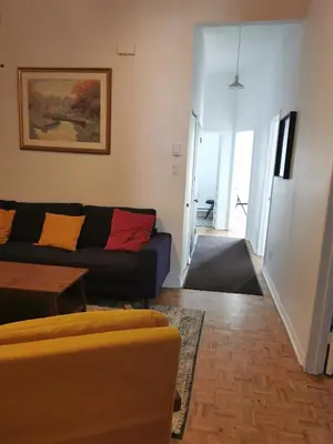 a living room with a couch and a table at Grand Appartement centre-ville 1227, 3 chambres in Montréal