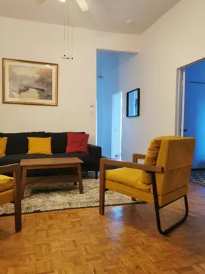 a living room with two chairs and a couch at Grand Appartement centre-ville 1227, 3 chambres in Montréal