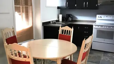 a kitchen with a table and chairs and a sink at Appartement centre-ville Montréal 1215 LT in Montréal
