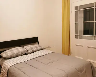 a bedroom with a bed with two pillows and a window at Appartement centre-ville Montréal 1215 LT in Montréal