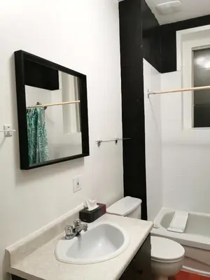 a bathroom with a sink and a toilet and a mirror at Appartement centre-ville Montréal 1215 LT in Montréal