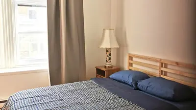 a bedroom with a bed and a lamp and a window at Appartement centre-ville Montréal 1215 LT in Montréal