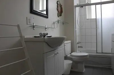 a bathroom with a sink and a toilet and a shower at Magnifique 3 chambres Centre ville 1217 in Montréal