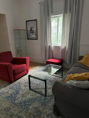 a living room with a red couch and a glass table at Magnifique 3 chambres Centre ville 1217 in Montréal