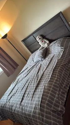a stuffed animal sitting on top of a bed at Spacious 4-Bdr Retreat in Charming Ste-Rose, Laval in Laval