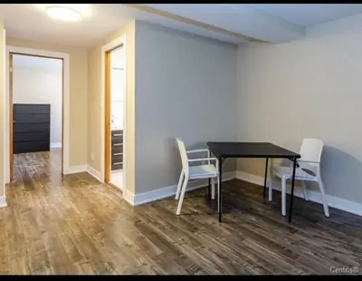 a dining room with a table and two chairs at Spacious 4-Bdr Retreat in Charming Ste-Rose, Laval in Laval