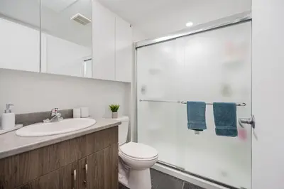 a bathroom with a toilet and a glass shower at Top Location - Cozy & Bright MTL studio near metro in Montréal