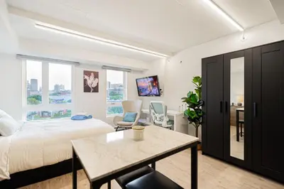 a bedroom with a bed and a table in a room at Top Location - Cozy & Bright MTL studio near metro in Montréal
