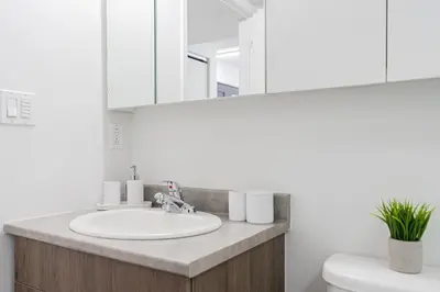 a bathroom with a sink and a mirror at Top Location - Cozy & Bright MTL studio near metro in Montréal
