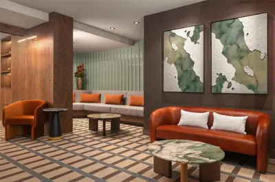 a lobby with a couch and a map on the wall at Hotel Railwayparc Montreal, Tapestry Collection By Hilton in Montréal