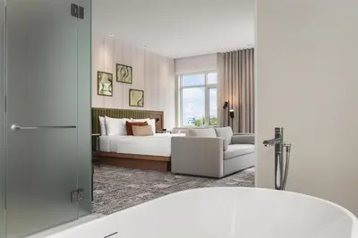 a hotel room with a bed and a bath tub at Hotel Railwayparc Montreal, Tapestry Collection By Hilton in Montréal