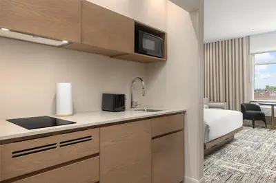 a kitchen with a sink and a microwave at Hotel Railwayparc Montreal, Tapestry Collection By Hilton in Montréal