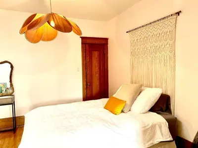 a bedroom with a white bed with a yellow pillow at Beautiful Sunny big apartment in Montréal