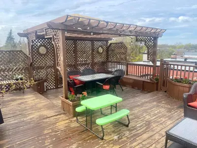 a patio with a table and chairs on a deck at Beautiful Sunny big apartment in Montréal