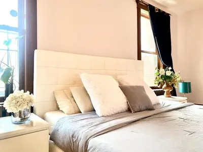 a bedroom with a large white bed with pillows at Beautiful Sunny big apartment in Montréal