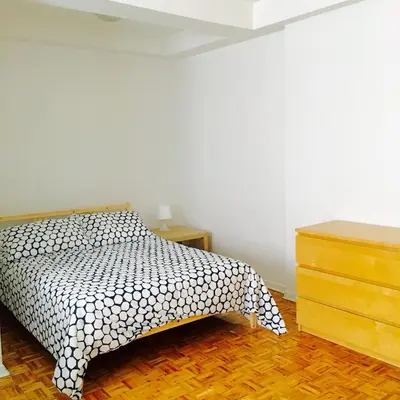 a bedroom with a bed with a black and white bedspread at Stylish Montreal Apartment Comfortable Stay in the Golden Square Mile in Montréal