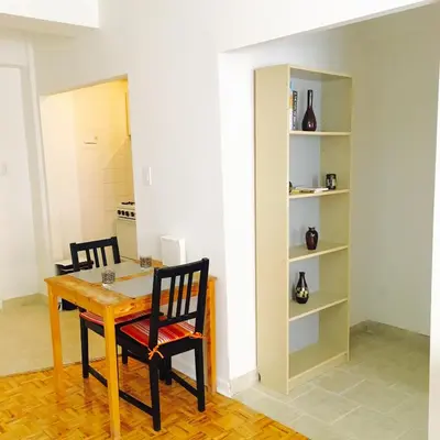 a dining room with a wooden table and chairs at Stylish Montreal Apartment Comfortable Stay in the Golden Square Mile in Montréal