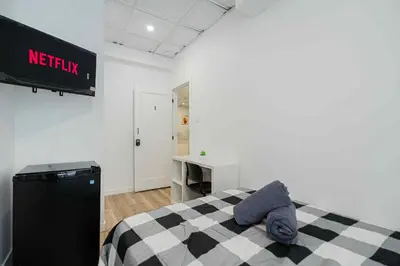 a bedroom with a bed and a sign on the wall at Room n1-Apartment 1 in a SHARED apartment in downtown Montreal in Montréal