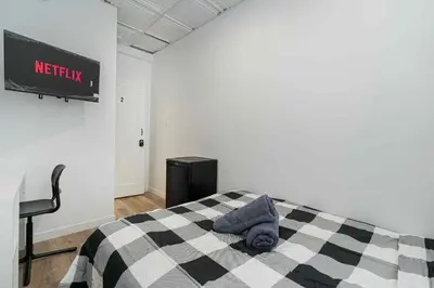 a bedroom with a bed with a checkered blanket at Room n2-Apartment 1 in a SHARED apartment in downtown Montreal in Montréal