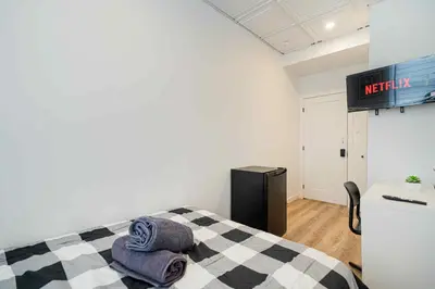 a bedroom with a bed with two towels on it at Room n3-Apartment 1 in a SHARED apartment in downtown Montreal in Montréal