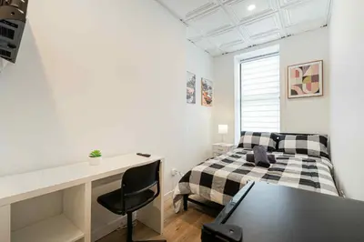 a bedroom with a bed and a desk and a table at Room n3-Apartment 1 in a SHARED apartment in downtown Montreal in Montréal