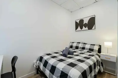 a bedroom with a black and white checkered bed at Room n4-Apartment 1 in a SHARED apartment in downtown Montreal in Montréal