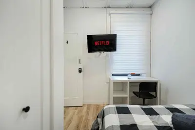 a bedroom with a bed and a desk with a monitor at Room n5-Apartment 1 in a SHARED apartment in downtown Montreal in Montréal