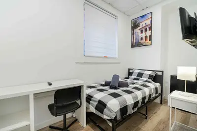 a bedroom with a bed and a desk and a window at Room n6-Apartment 1 in a SHARED apartment in downtown Montreal in Montréal