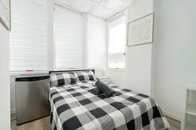 a bedroom with a black and white checkered bed at Room n7-Apartment 1 in a SHARED apartment in downtown Montreal in Montréal
