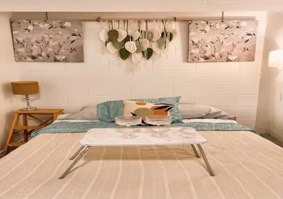 a room with a bed with a table and a couch at House 5 bedrooms - close to metro in Montréal