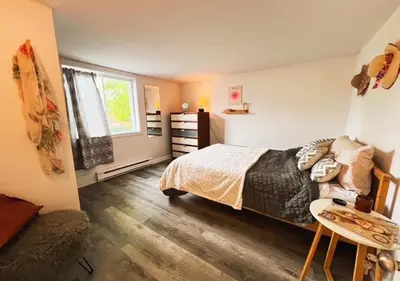 a bedroom with a bed and a desk and a window at House 5 bedrooms - close to metro in Montréal