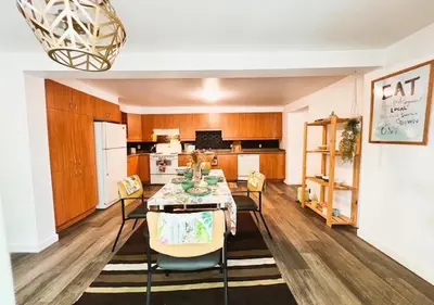 a kitchen with a table and chairs in a room at House 5 bedrooms - close to metro in Montréal