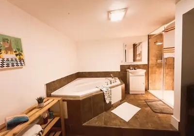 a large bathroom with a tub and a shower at House 5 bedrooms - close to metro in Montréal